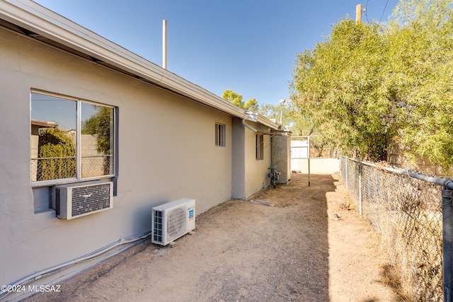 view of side of home featuring cooling unit and ac unit