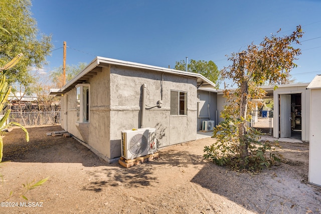 back of house with ac unit