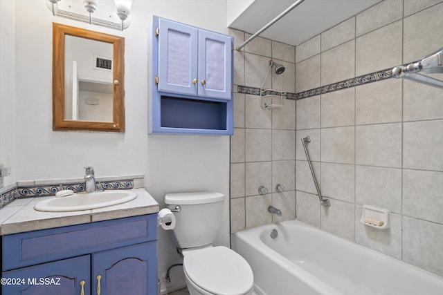 full bathroom featuring toilet, tiled shower / bath combo, and vanity