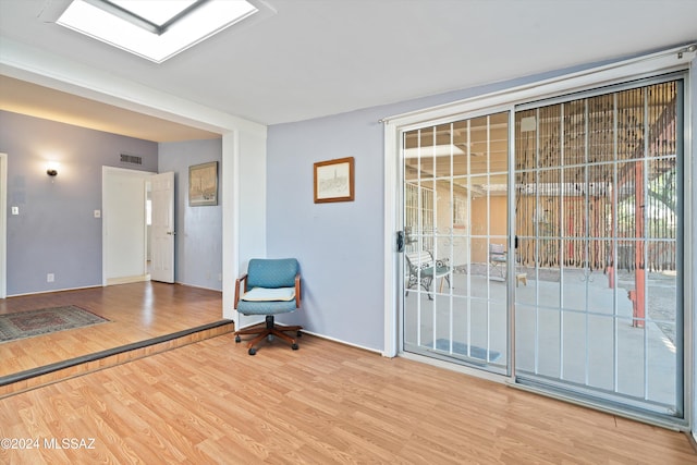 sitting room with wood-type flooring