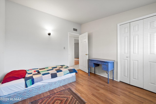 bedroom with a closet and light wood-type flooring