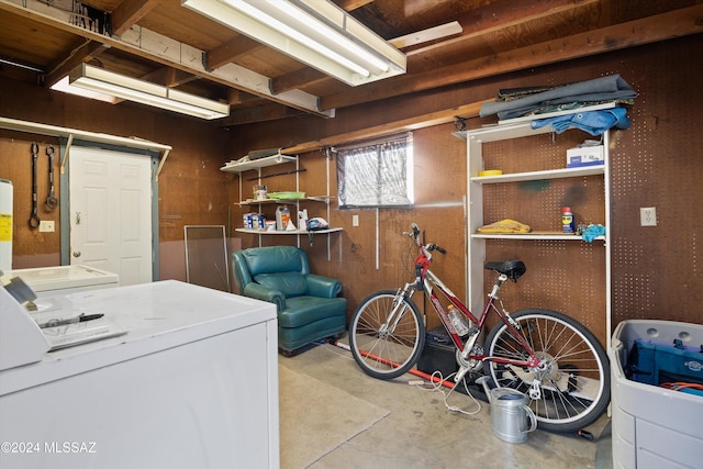 interior space featuring wooden walls and separate washer and dryer