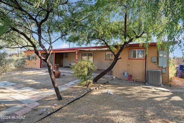 rear view of house with a patio area and central AC