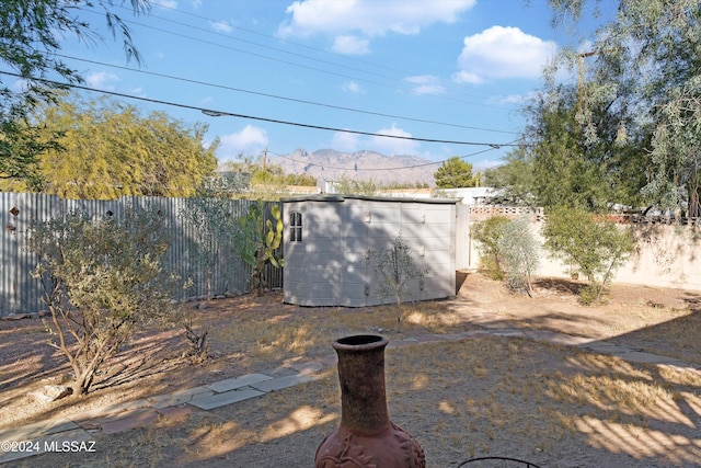 view of yard with a mountain view and a storage unit