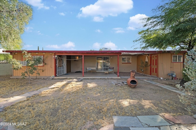 back of property with a patio