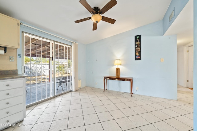 tiled spare room with ceiling fan