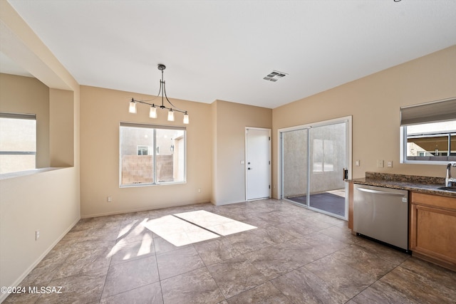 kitchen featuring decorative light fixtures, a chandelier, and stainless steel dishwasher