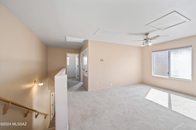 carpeted spare room featuring ceiling fan