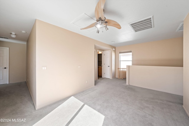 unfurnished room featuring light carpet