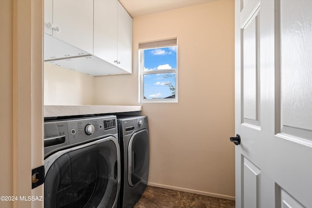 laundry area with washer and clothes dryer and cabinets