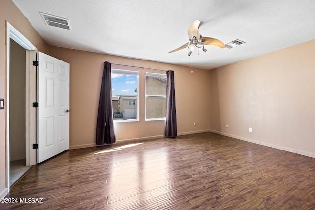 unfurnished room with ceiling fan, a textured ceiling, and dark hardwood / wood-style flooring