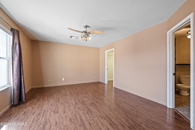 unfurnished room with dark wood-type flooring and ceiling fan