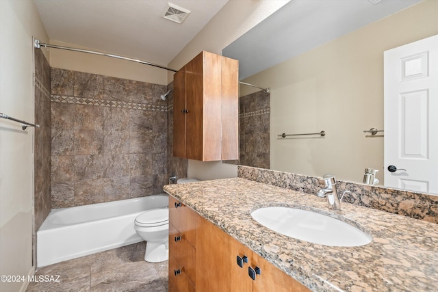 full bathroom with vanity, toilet, and tiled shower / bath