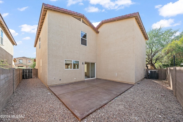 rear view of house with a patio and central AC