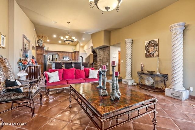 tiled living room with lofted ceiling, decorative columns, and a notable chandelier