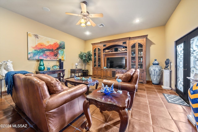 tiled living room with french doors and ceiling fan