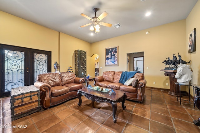 tiled living room featuring french doors and ceiling fan