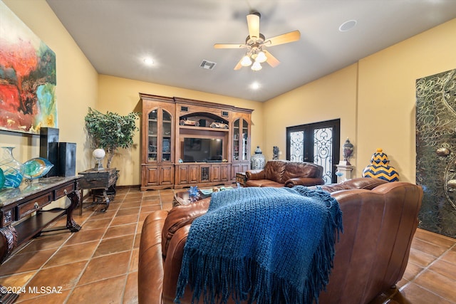 living room with dark tile patterned flooring and ceiling fan