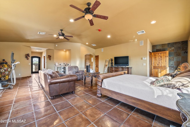 tiled bedroom with ceiling fan and vaulted ceiling