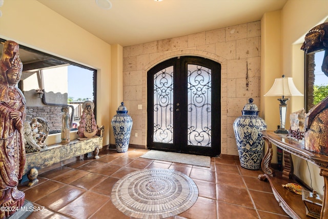 tiled entrance foyer with french doors and tile walls