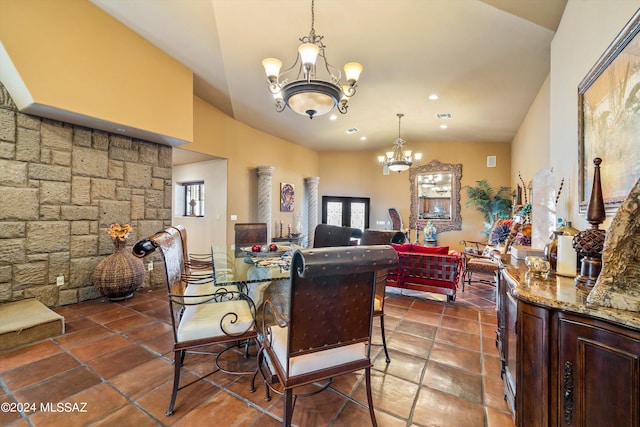 dining space featuring a chandelier and high vaulted ceiling