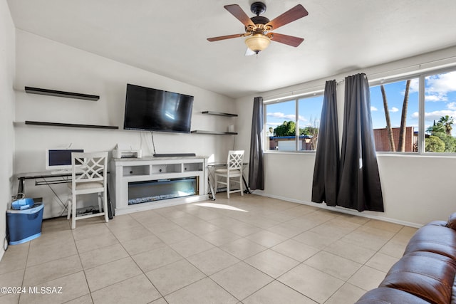 living room featuring ceiling fan, lofted ceiling, and light tile patterned flooring