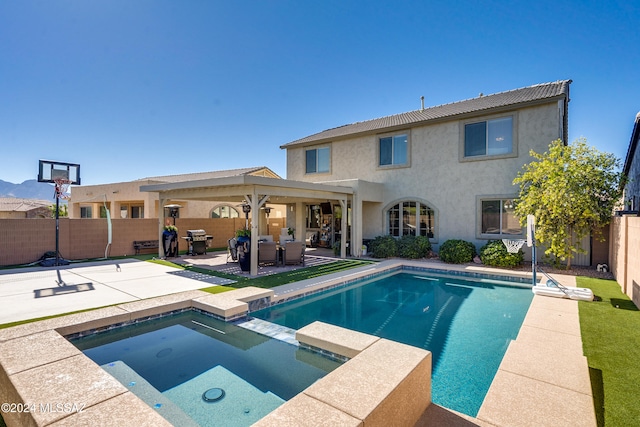 view of pool featuring an in ground hot tub, a patio, a grill, and outdoor lounge area