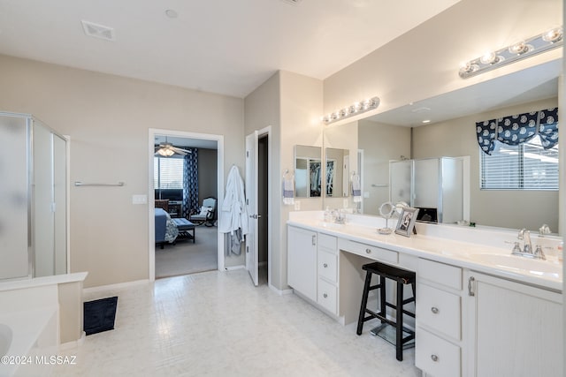 bathroom featuring a shower with door, vanity, and ceiling fan