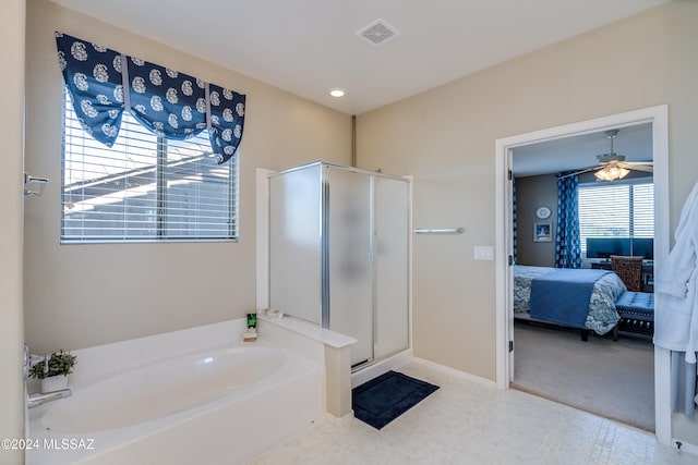 bathroom featuring ceiling fan, separate shower and tub, and a wealth of natural light