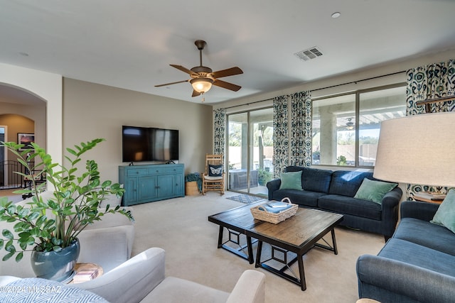 carpeted living room featuring ceiling fan