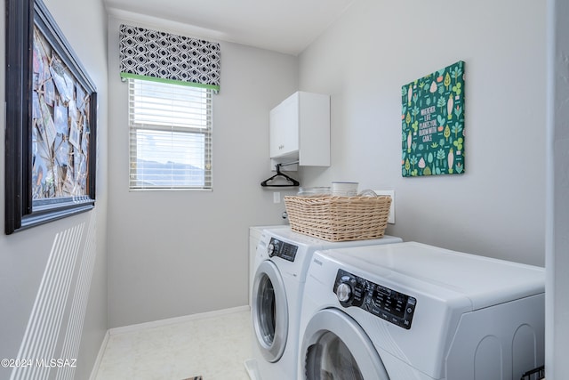 laundry area featuring cabinets and washer and clothes dryer