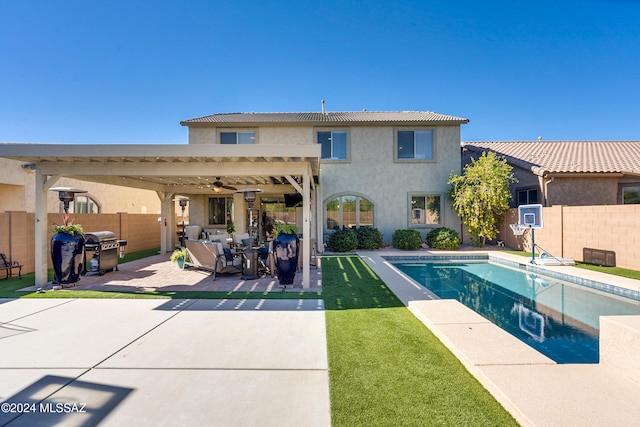 view of pool featuring a grill, a patio area, a lawn, and ceiling fan