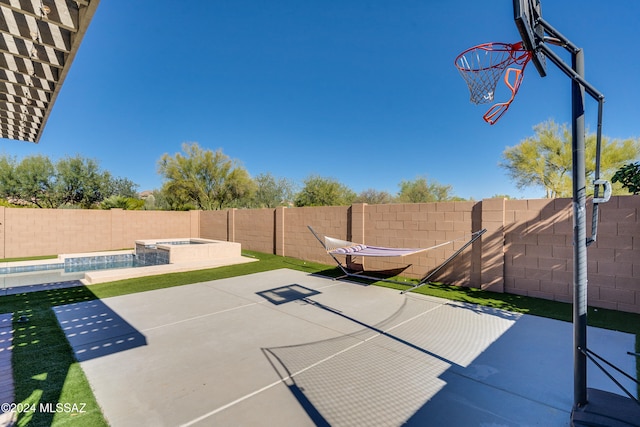 view of basketball court featuring a fenced in pool