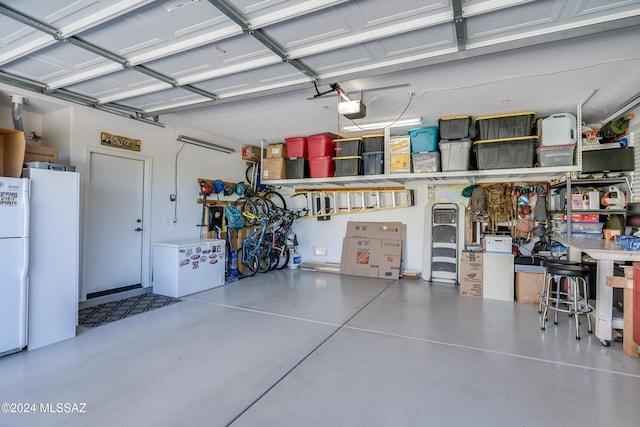 garage with a garage door opener and white refrigerator