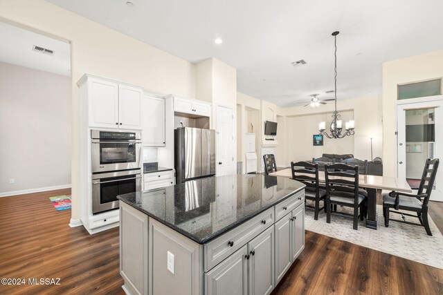 1220 W Calabria Ct, Tucson, AZ 85755 - kitchen with stainless steel appliances, dark wood-style flooring, a kitchen island, and white cabinets