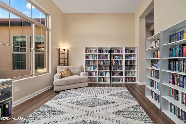 1220 W Calabria Ct, Tucson, AZ 85755 - living area with wood finished floors, baseboards, and wall of books