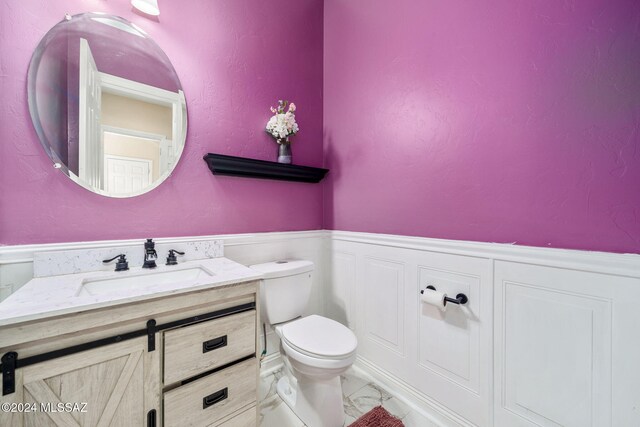 bathroom featuring vanity and toilet