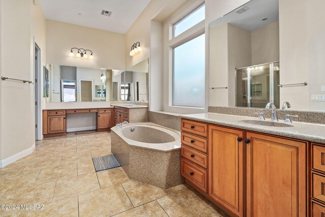 bathroom with plus walk in shower, vanity, tile patterned flooring, and plenty of natural light