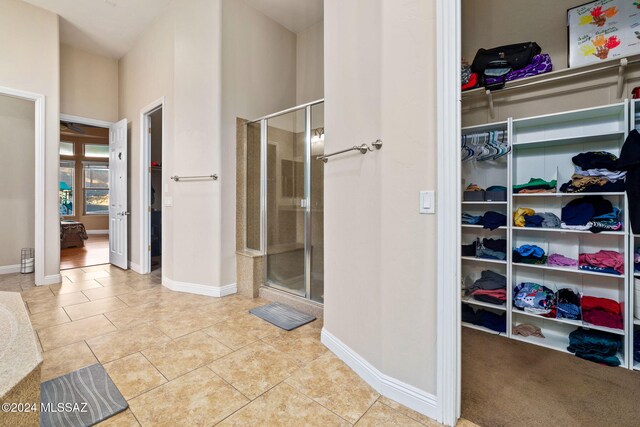 bathroom featuring tile patterned floors and a shower with door