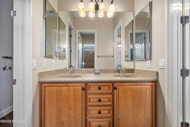 1220 W Calabria Ct, Tucson, AZ 85755 - bathroom featuring double vanity and a chandelier