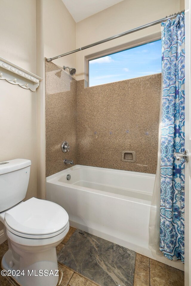 bathroom with shower / bath combo and toilet