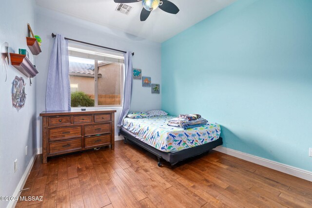 bedroom with hardwood / wood-style floors and ceiling fan