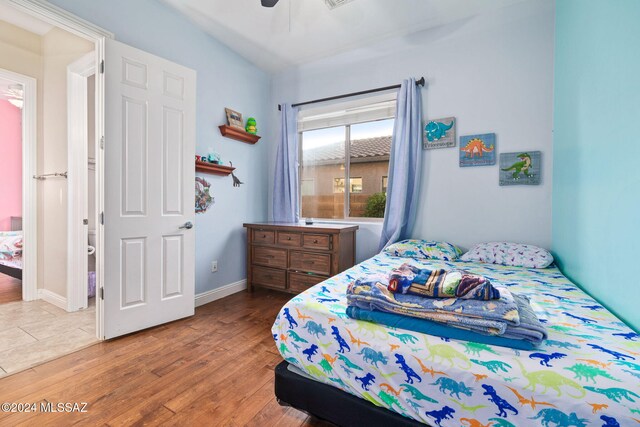 bedroom with hardwood / wood-style flooring and ceiling fan