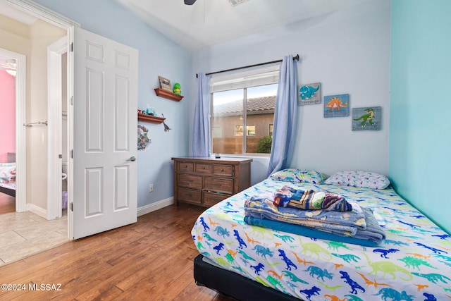 1220 W Calabria Ct, Tucson, AZ 85755 - bedroom featuring wood finished floors, baseboards, and a ceiling fan
