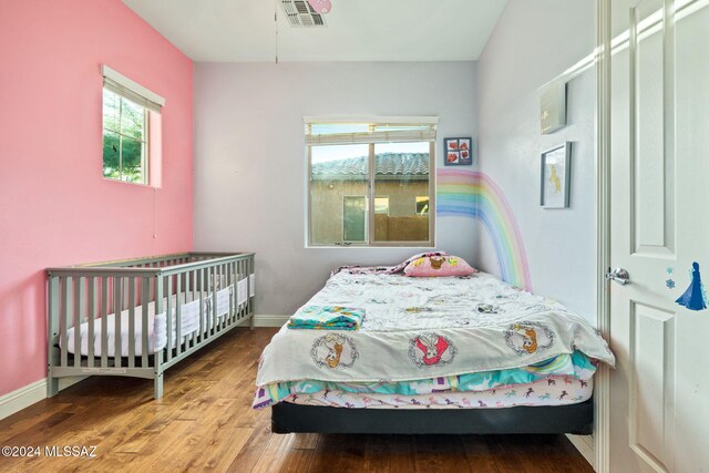 bedroom with wood-type flooring