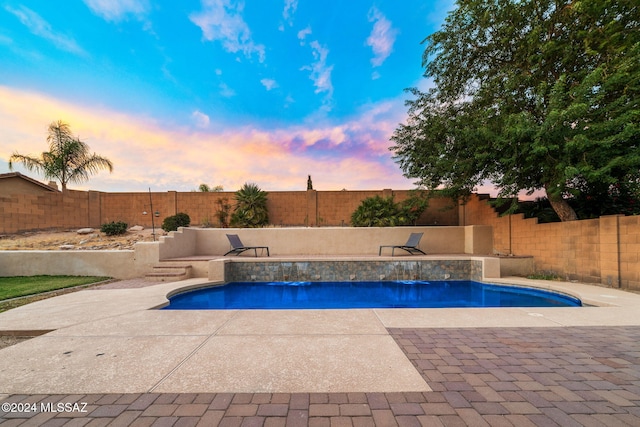 1220 W Calabria Ct, Tucson, AZ 85755 - pool at dusk with a fenced backyard and a patio area