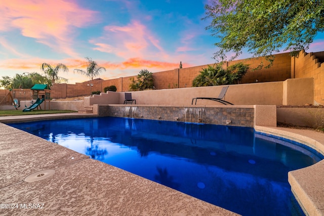 1220 W Calabria Ct, Tucson, AZ 85755 - pool at dusk with a fenced backyard and a playground