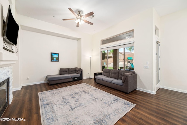 1220 W Calabria Ct, Tucson, AZ 85755 - living area with a ceiling fan, dark wood finished floors, a fireplace, and baseboards