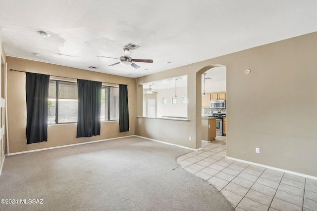 carpeted empty room with ceiling fan