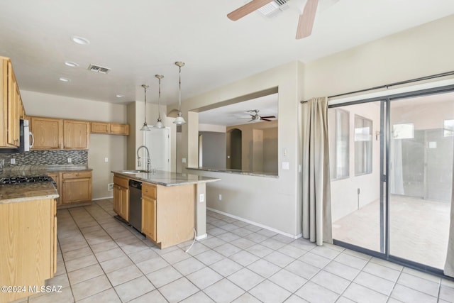 kitchen with light stone countertops, sink, pendant lighting, dishwasher, and an island with sink